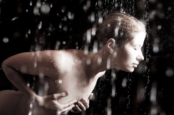 stock image Young woman under the flying drops.