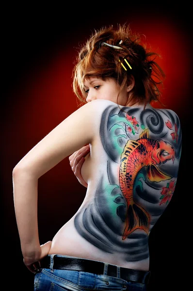 stock image The girl and the red carp (body art)